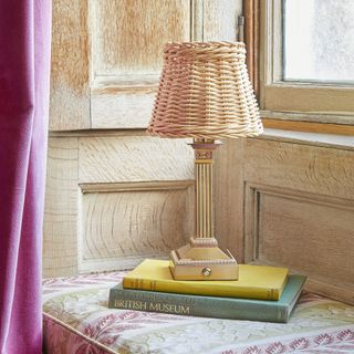 Freya rechargeable table lamp displayed on side table with decorative book stack