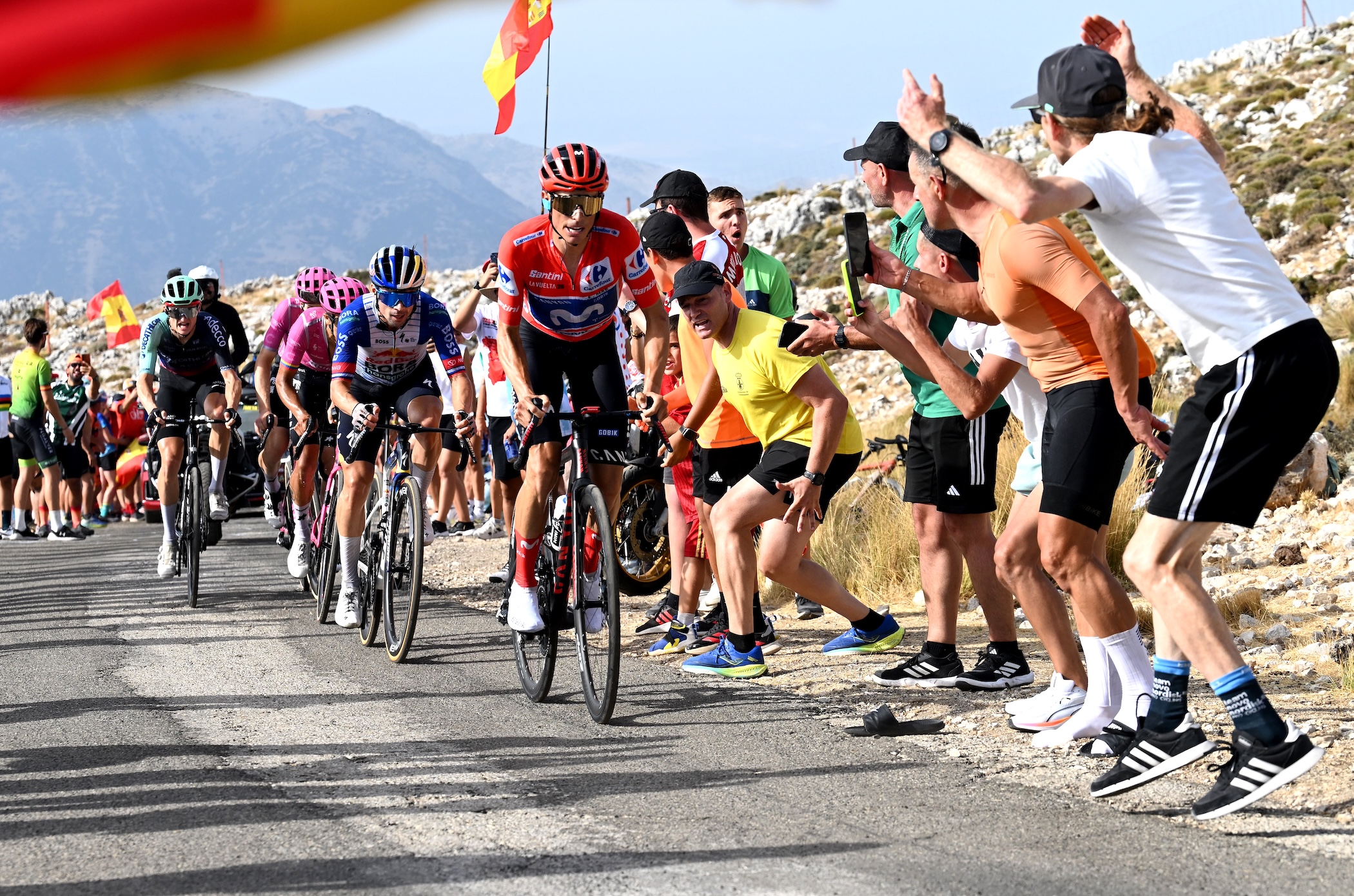 Enric Mas of Movistar Team leads a group of GC contenders, including Primož Roglič of Red Bull-Bora-Hansgrohe on final climb of stage 14