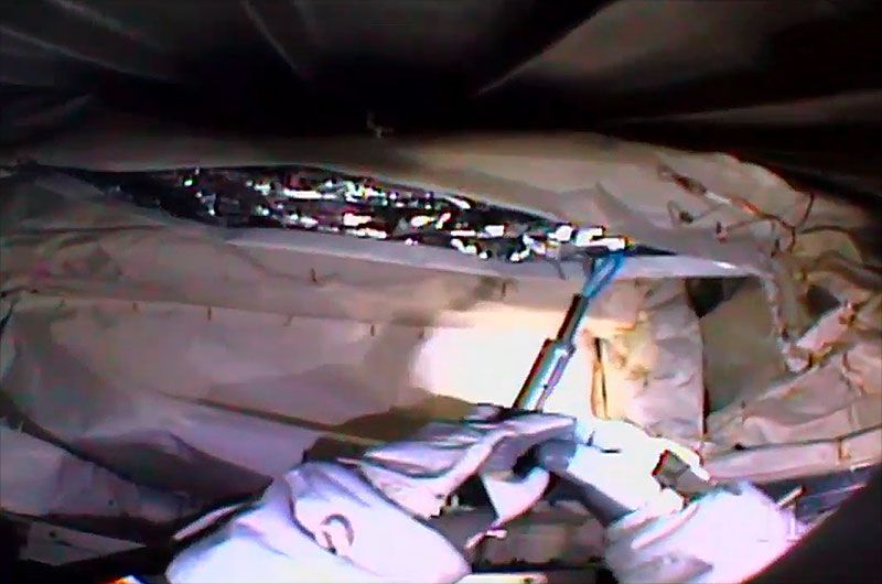 Astronaut Luca Parmitano uses a cutter developed by engineering students to snip zip ties on the Alpha Magnetic Spectrometer during a spacewalk on Friday, Nov. 15, 2019.