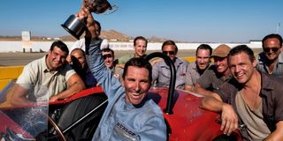 Christian Bale as Ken Miles holding a trophy in Ford v Ferrari