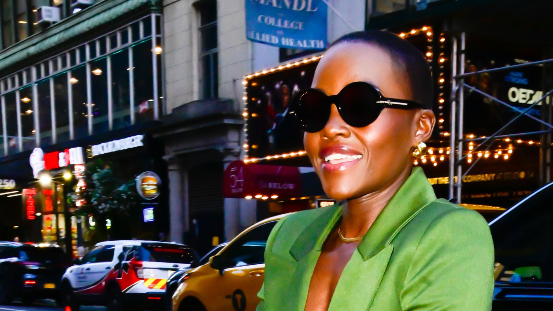 Lupita nyong&#039;o wearing a a green suit