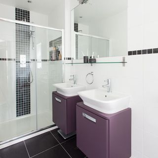 bathroom with shower and white tiles wall with wash basin and mirror