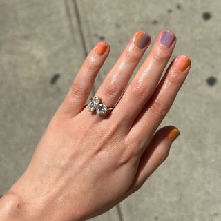 Woman wearing toi et moi–style marquis diamond engagement ring.