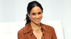 Meghan Markle, wearing a bronze shirt and trousers, speaks during the 'Responsible Digital Future' forum in Bogota on August 15, 2024