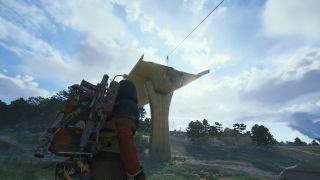 Arc Raiders Keeping an Eye Out: A player looking up at a destroyed highway in an open plain with a zipline to the top.