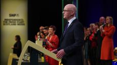 John Swinney speaking at a podium during the SNP party conference in 2025