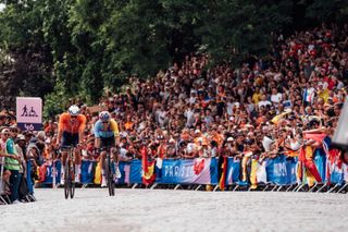 Paris, France - Men’s Road Race - Mathieu van der Poel (Netherlands) and Wout van Aert (Belgium) climbs the Côte De La Butte Montmartre passing crowds outside Basilique du Sacré-Cœur de Montmartre