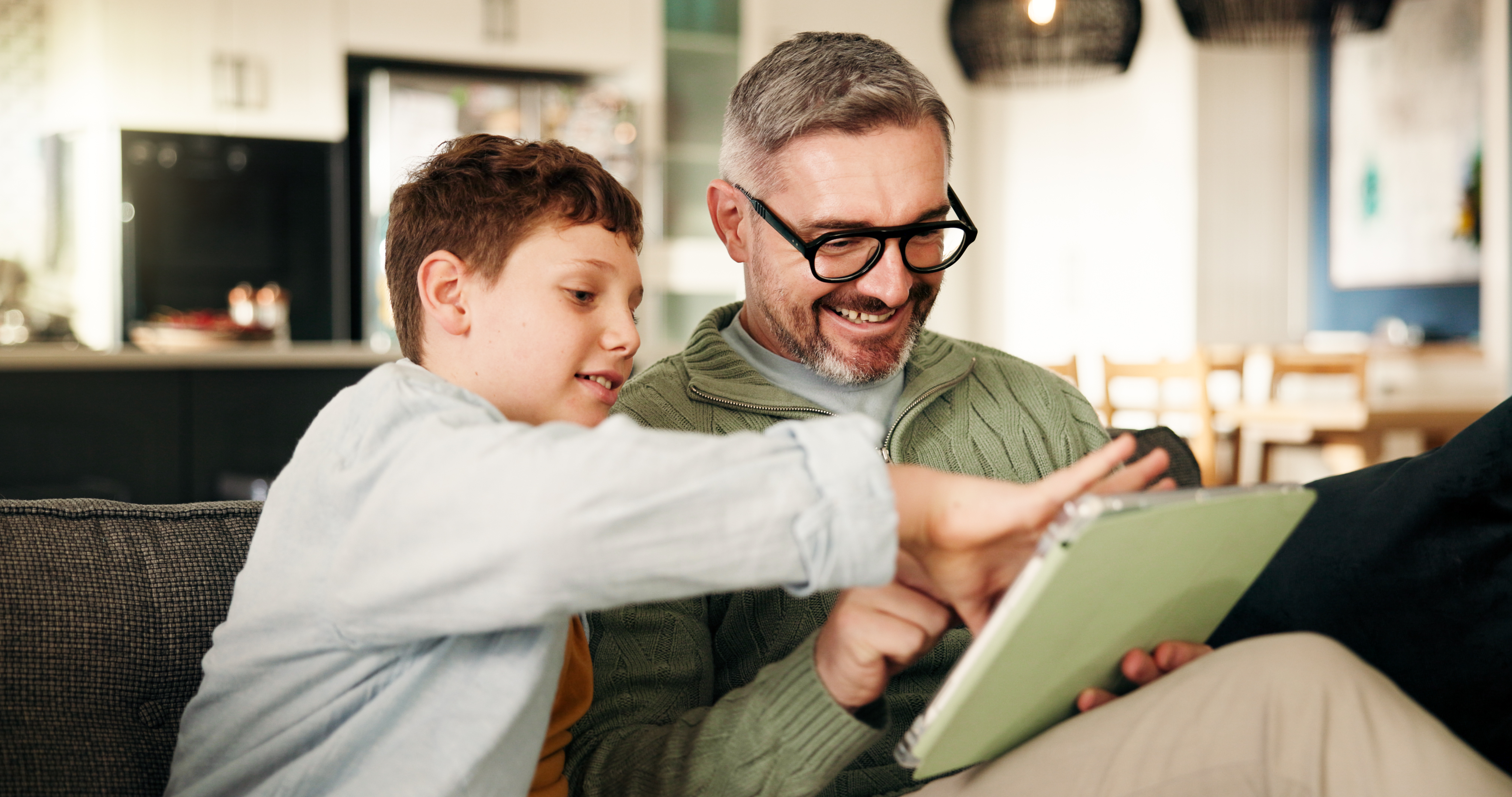 Home, grandfather and son on couch, tablet and bonding together with online game, support and smile. 