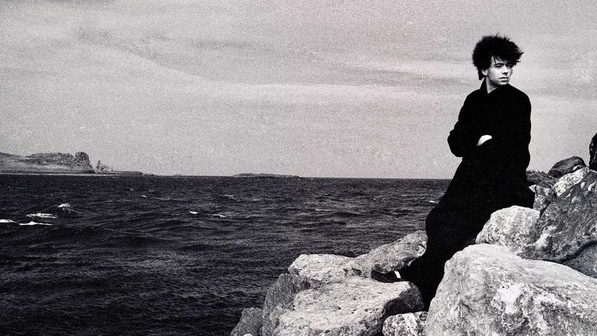 Ian McCulloch of Echo &amp; the Bunnymen sitting on rocks by the sea in Howth, Dublin, Ireland