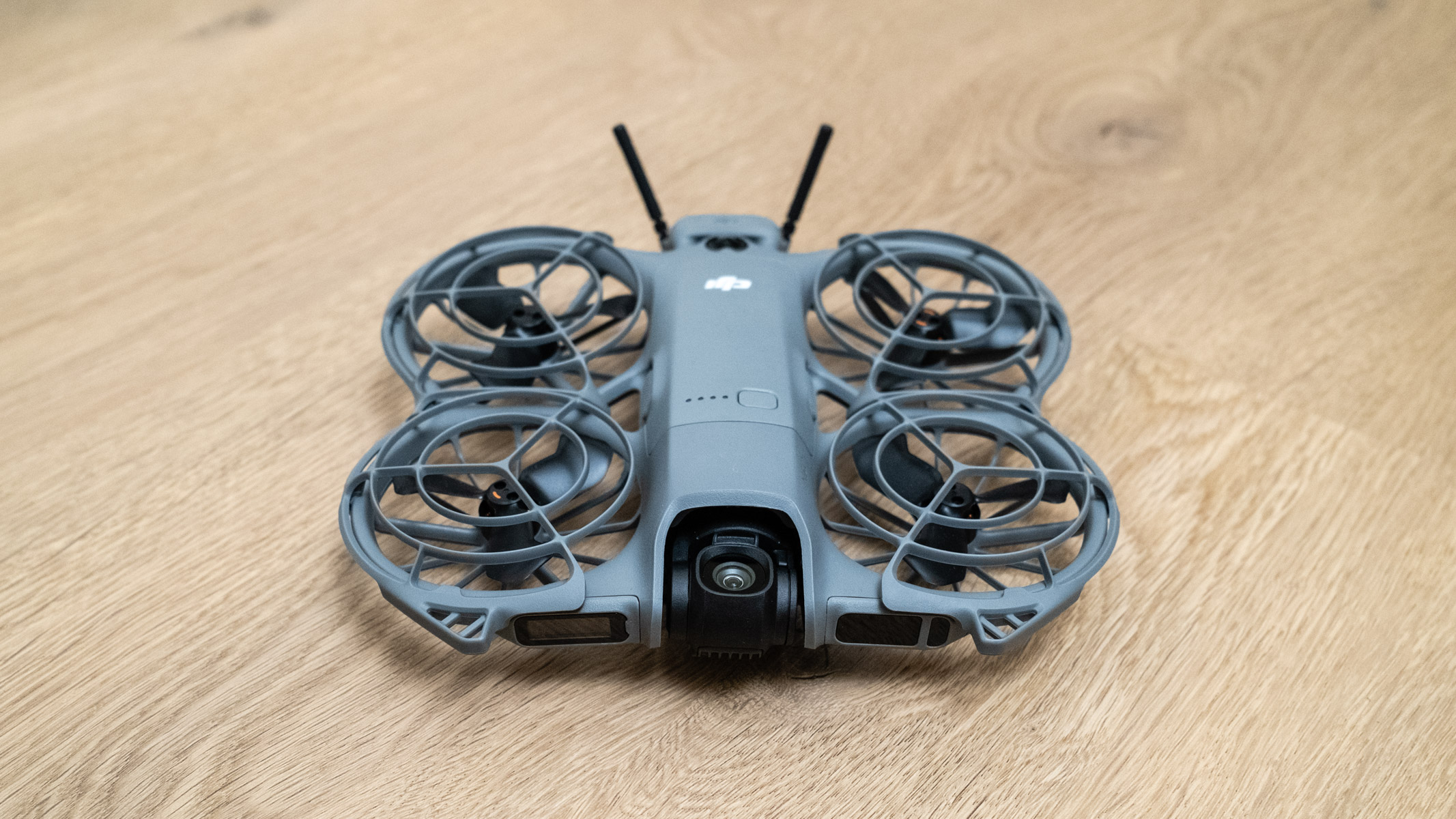 DJI Neo 2 front view on a wooden floor