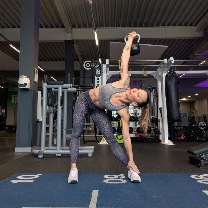 Woman exercising with kettlebell in gym
