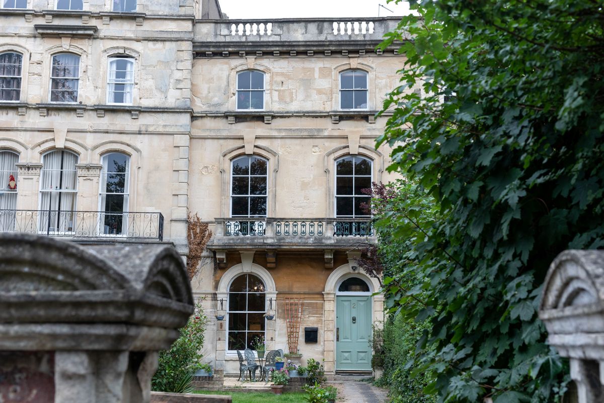 A three-storey period property with grey exterior walls