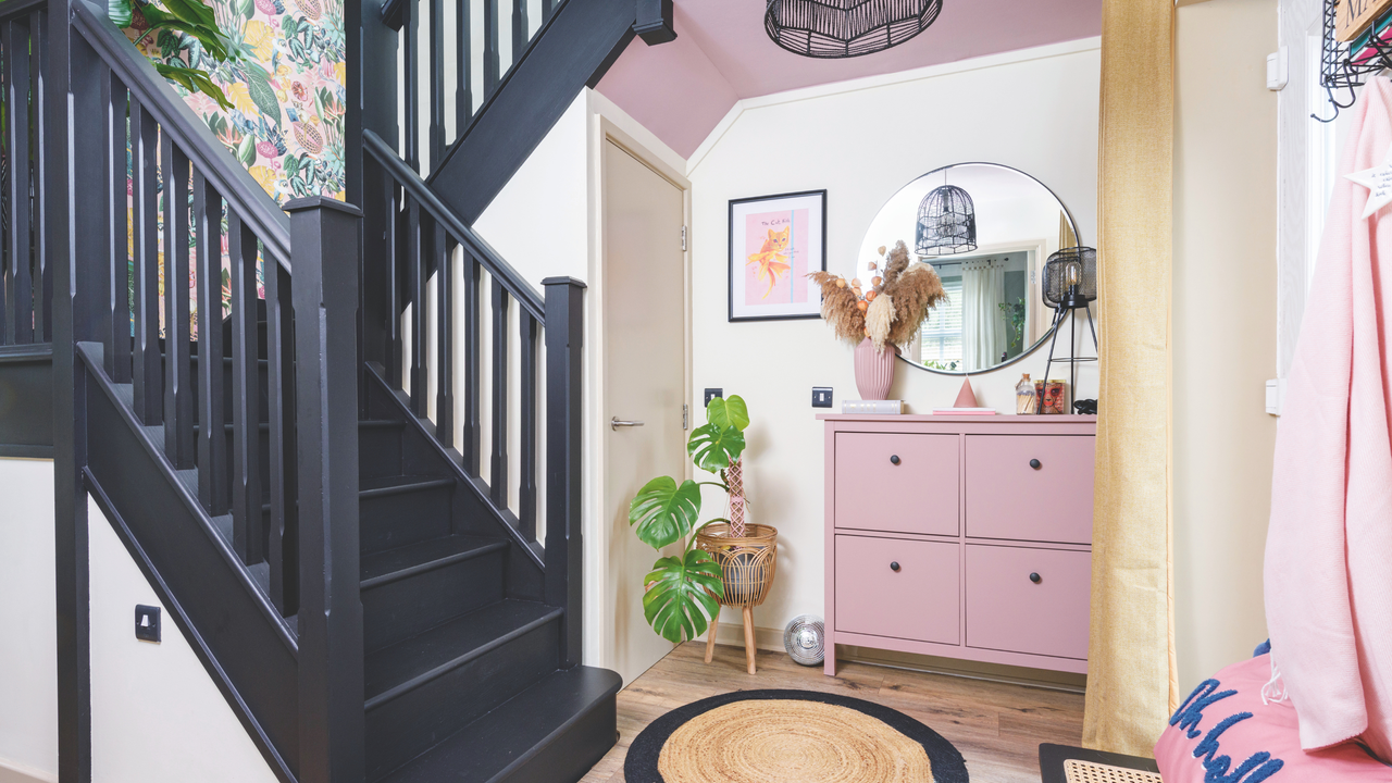 Black staircase, pink cabinets and decor