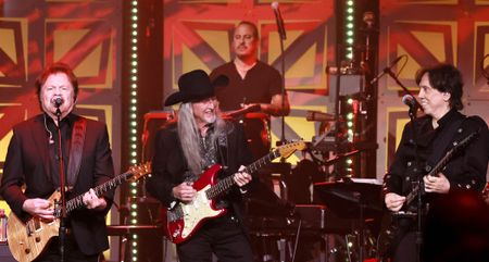 Tom Johnston, Patrick Simmons, and John McFee of The Doobie Brothers perform onstage in 2025.