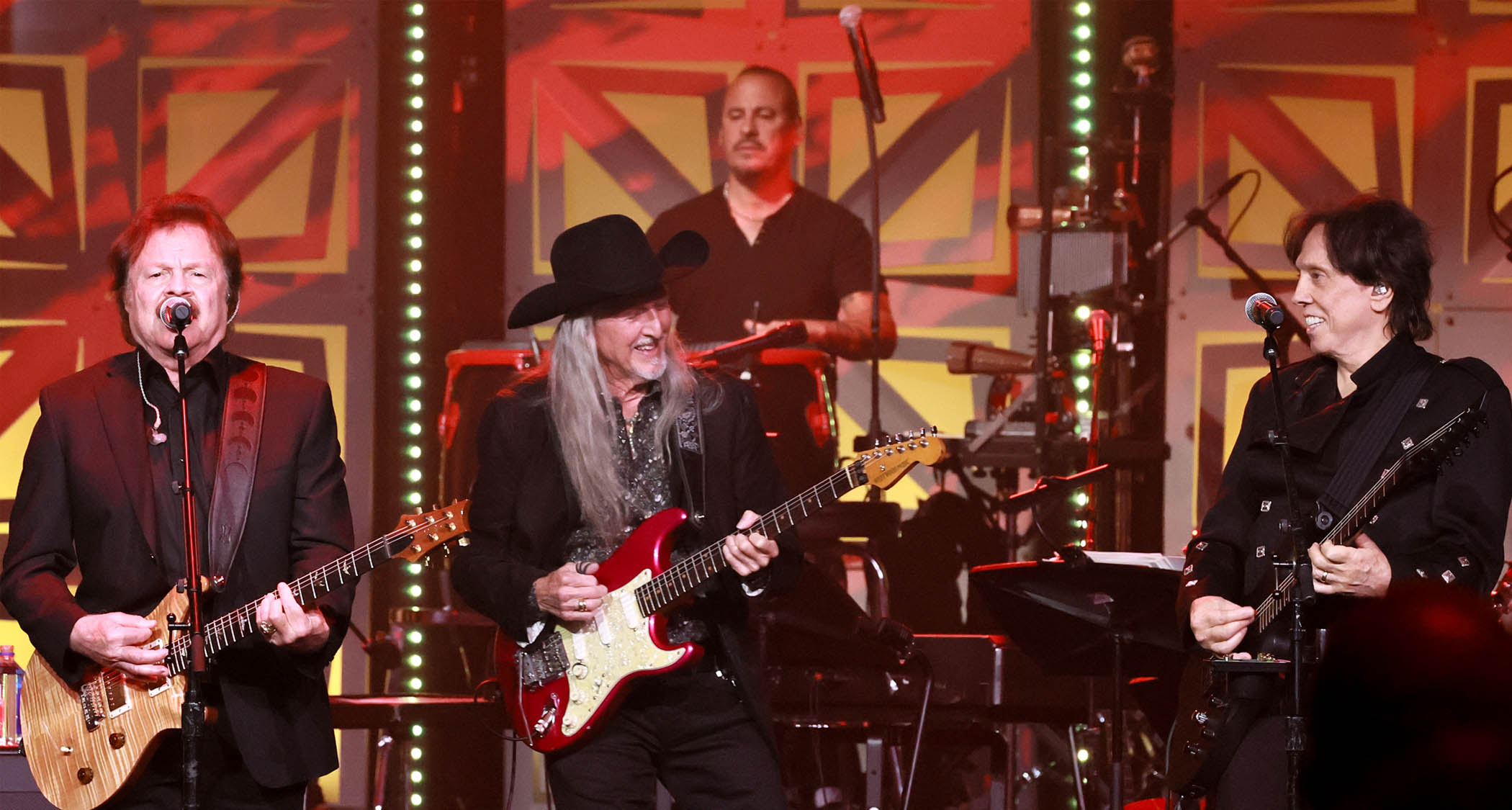Tom Johnston, Patrick Simmons, and John McFee of The Doobie Brothers perform onstage in 2025.