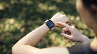 Woman using sports watch to check heart rate