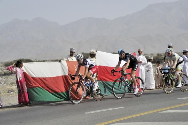 Racers pass Omani flags