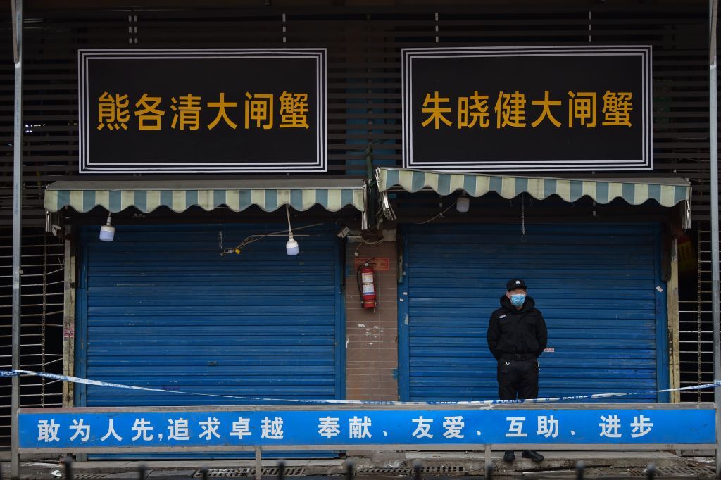 A security guard stands outside the Huanan Seafood Wholesale Market where the coronavirus was first detected in Wuhan in January 2020.