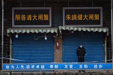A security guard stands outside the Huanan Seafood Wholesale Market where the coronavirus was first detected in Wuhan in January 2020.