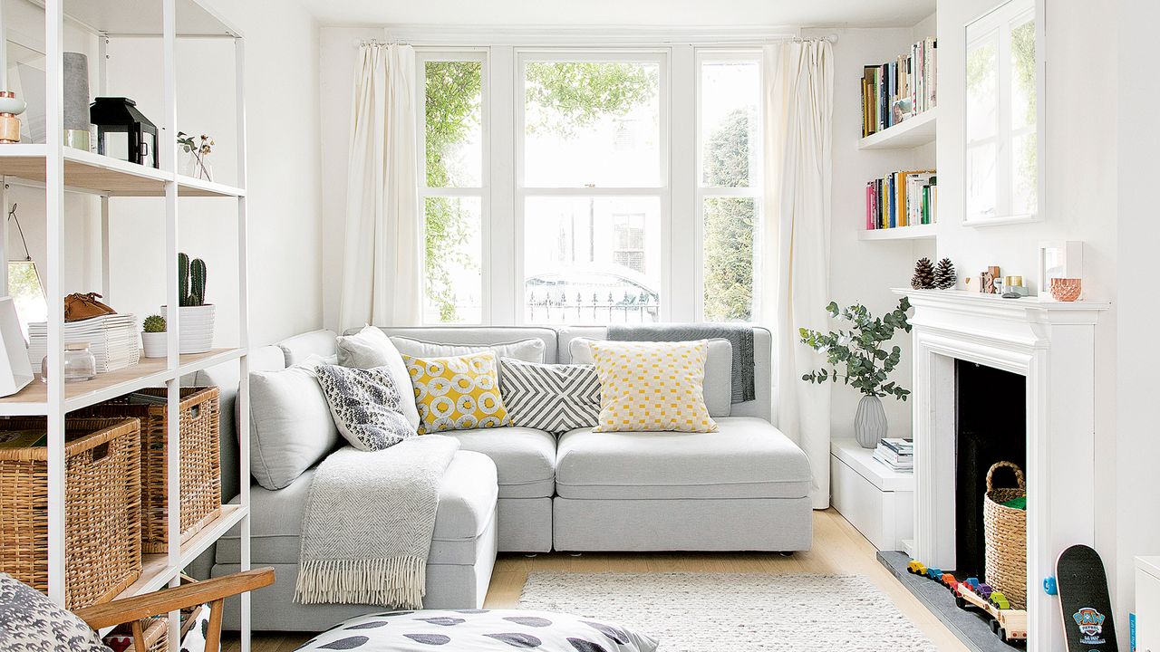 White living room with fireplace, L-shaped sofa and bean bag