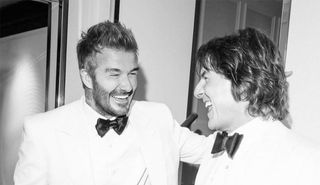 David Beckham and Tom Cruise laughing together wearing tuxedos at a party in Los Angeles