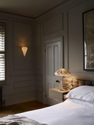 bedroom in dark grey walls and lamp with yellow light bulb