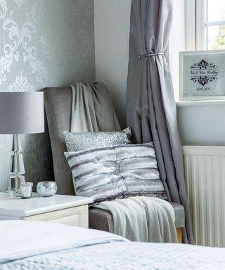 bedroom with grey curtains and lamp