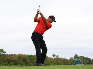 Tiger Woods hitting an iron on the driving range