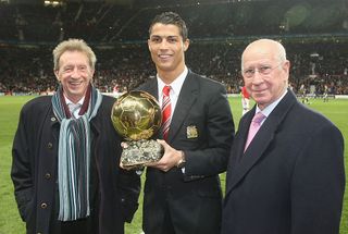 MANCHESTER, ENGLAND - DECEMBER 10: Cristiano Ronaldo of Manchester United is presented with the Ballon D'Or by Denis Law and Sir Bobby Charlton ahead of the UEFA Champions League Group E match between Manchester United and Aalborg BK at Old Trafford on December 10 2008 in Manchester, England. (Photo by John Peters/Manchester United via Getty Images)