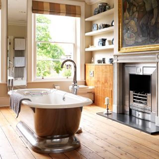 Copper bathtub with fireplace and large sash window