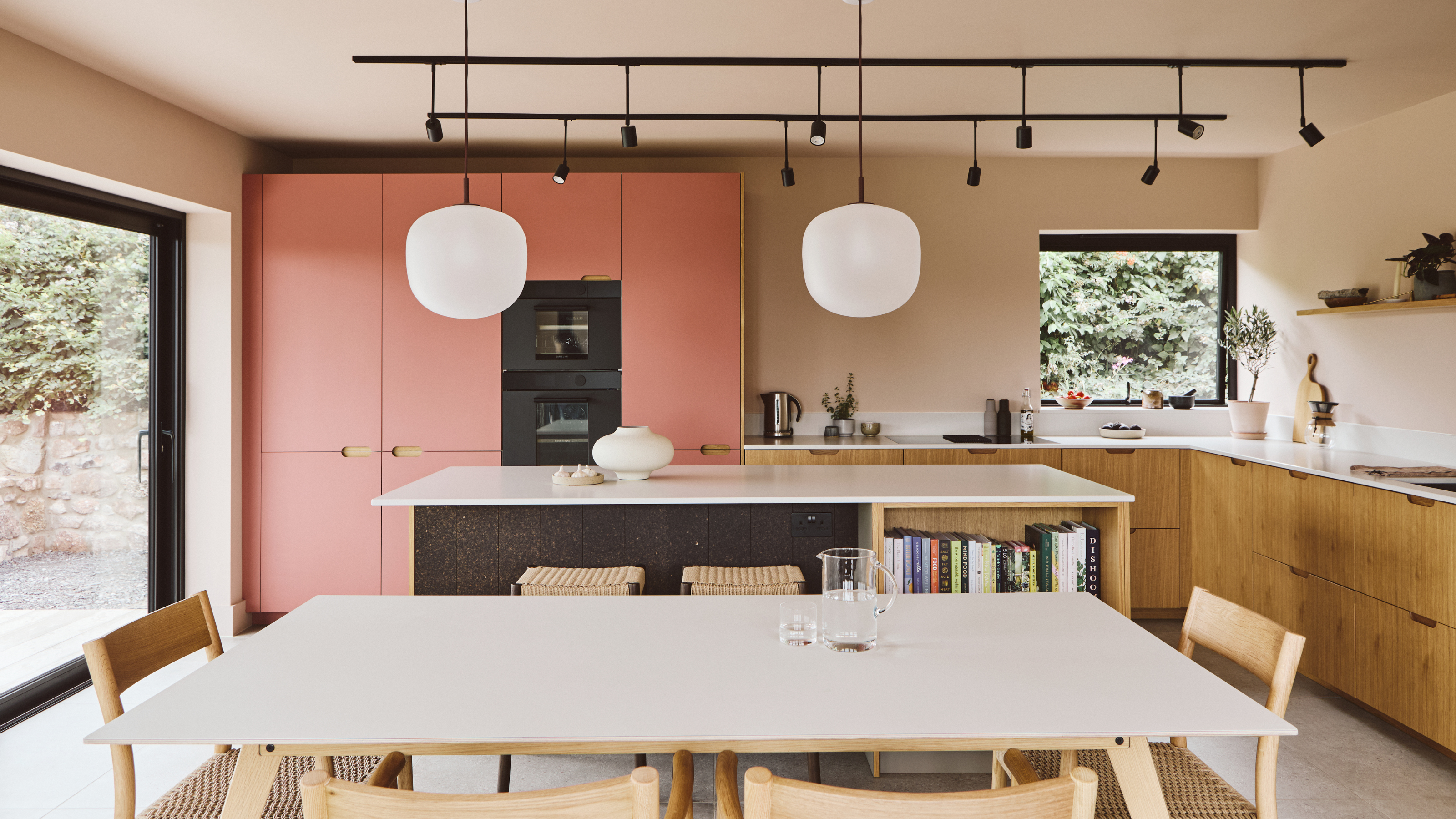 large kitchen extension with pendant lights and wooden cabinets