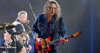 Kirk Hammett of Metallica wears a studded denim jacket as he plays live with his Mummy ESP signature guitar