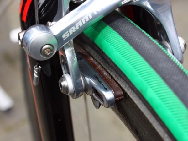 The SRAM Red cartridge holders are filled with older Shimano carbon-specific brake blocks.