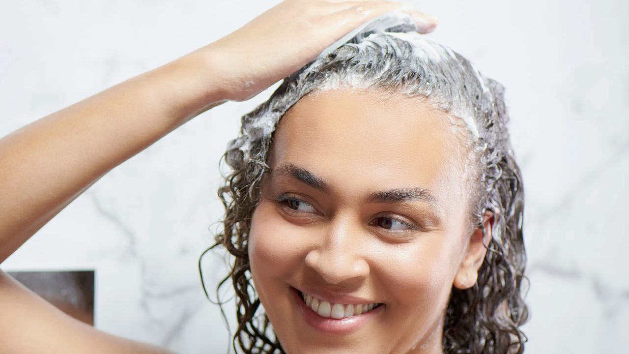 woman using scalp massager