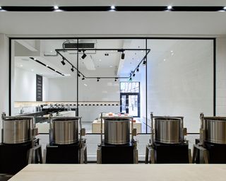 Floor-to-ceiling windows reveal the chocolate factory's metal drums