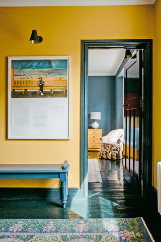 Yellow hallway with walls in Babouche by Farrow and ball with woodwork in Inchyra Blue