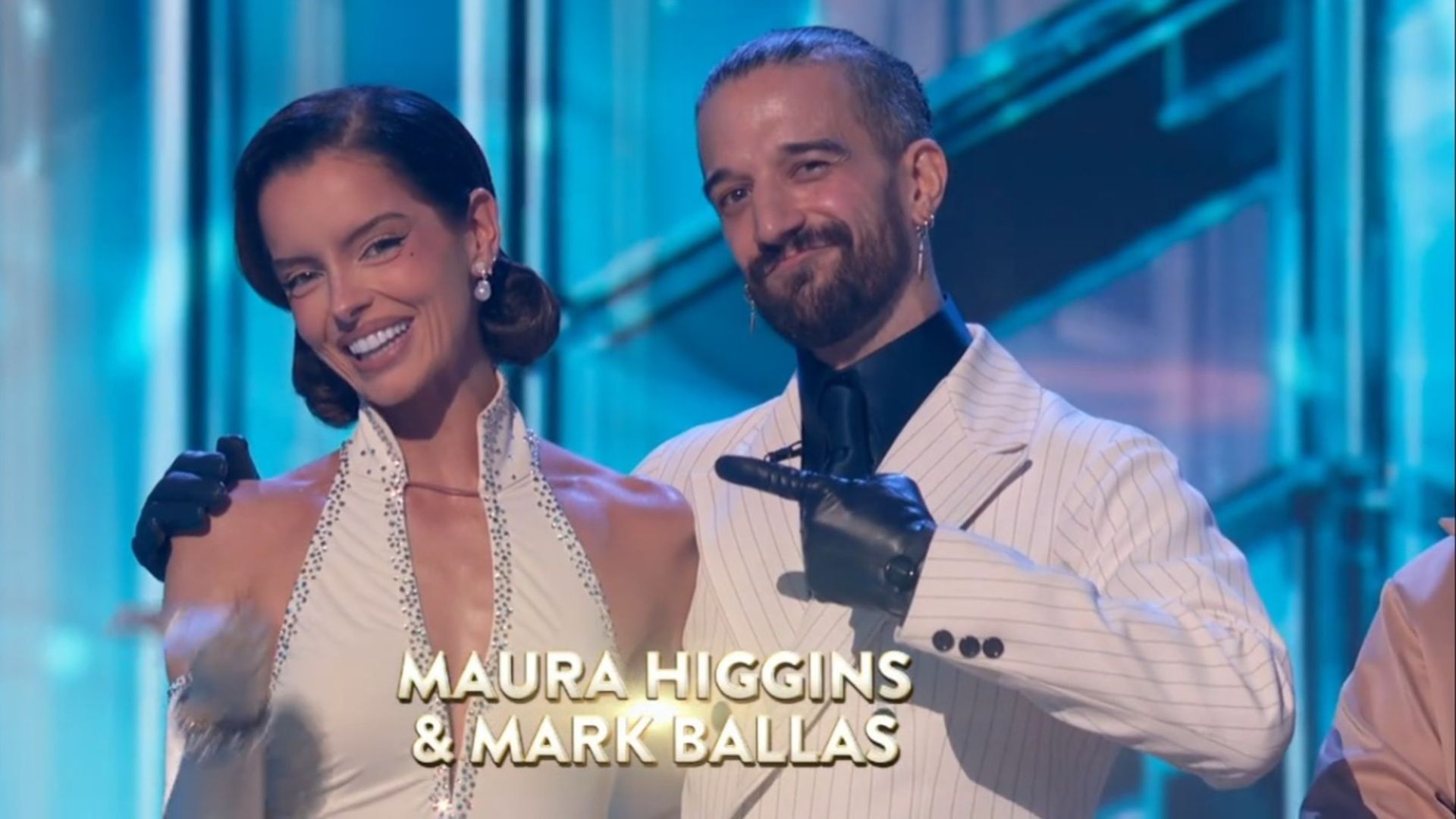 Maura Higgins and Mark Ballas standing and smiling in Dancing with the Stars.