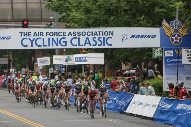 The women's peloton rolls through the finish line