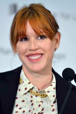 Molly Ringwald with soft dark eyes and glossy pink lips