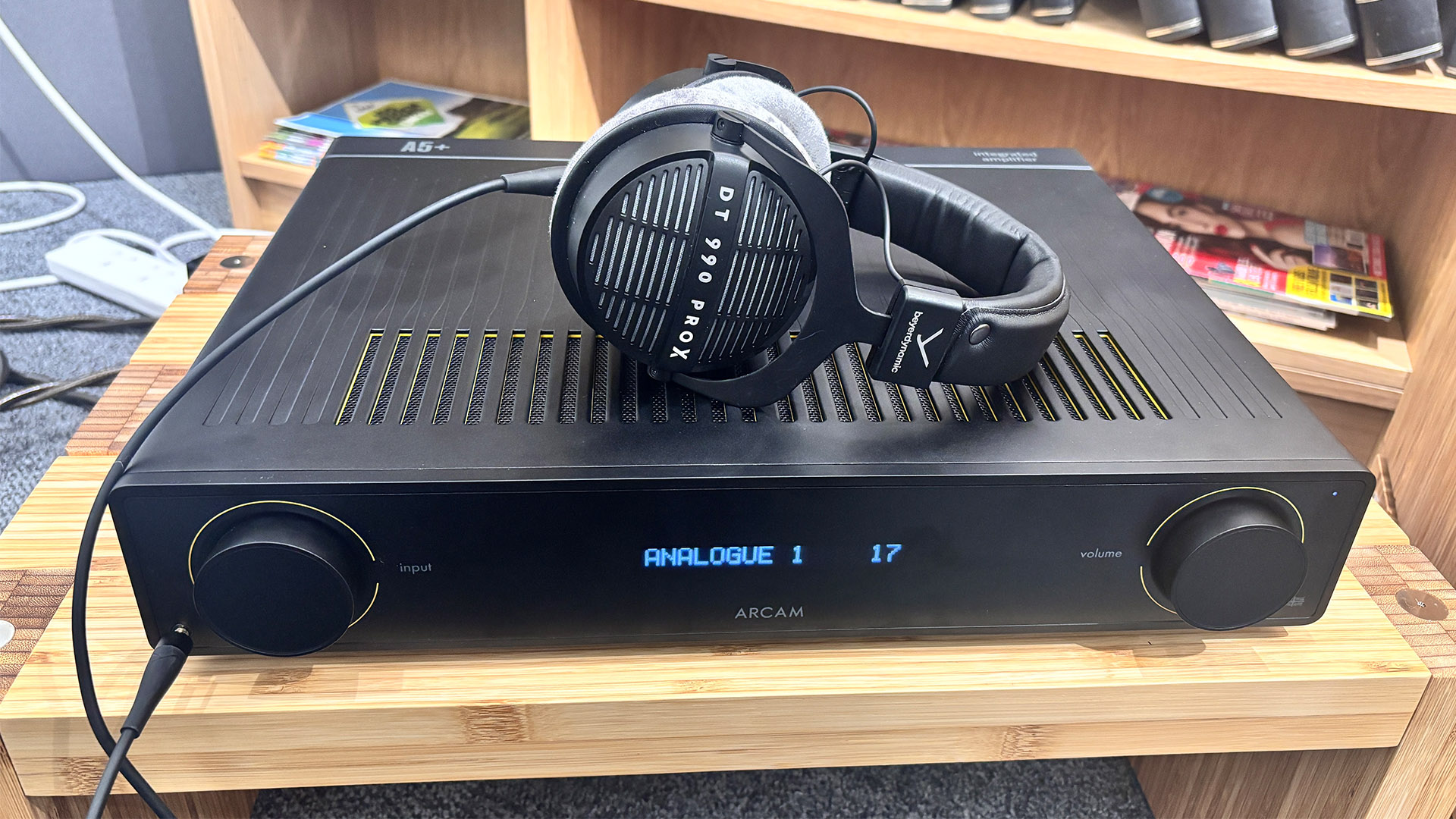 Arcam A5+ integrated amplifier on wooden hi-fi rack with Beyerdynamic headphones sitting on top
