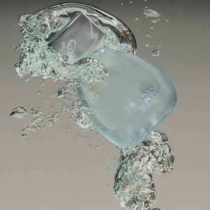 lore perfume sublimity with splash of water on gradient background