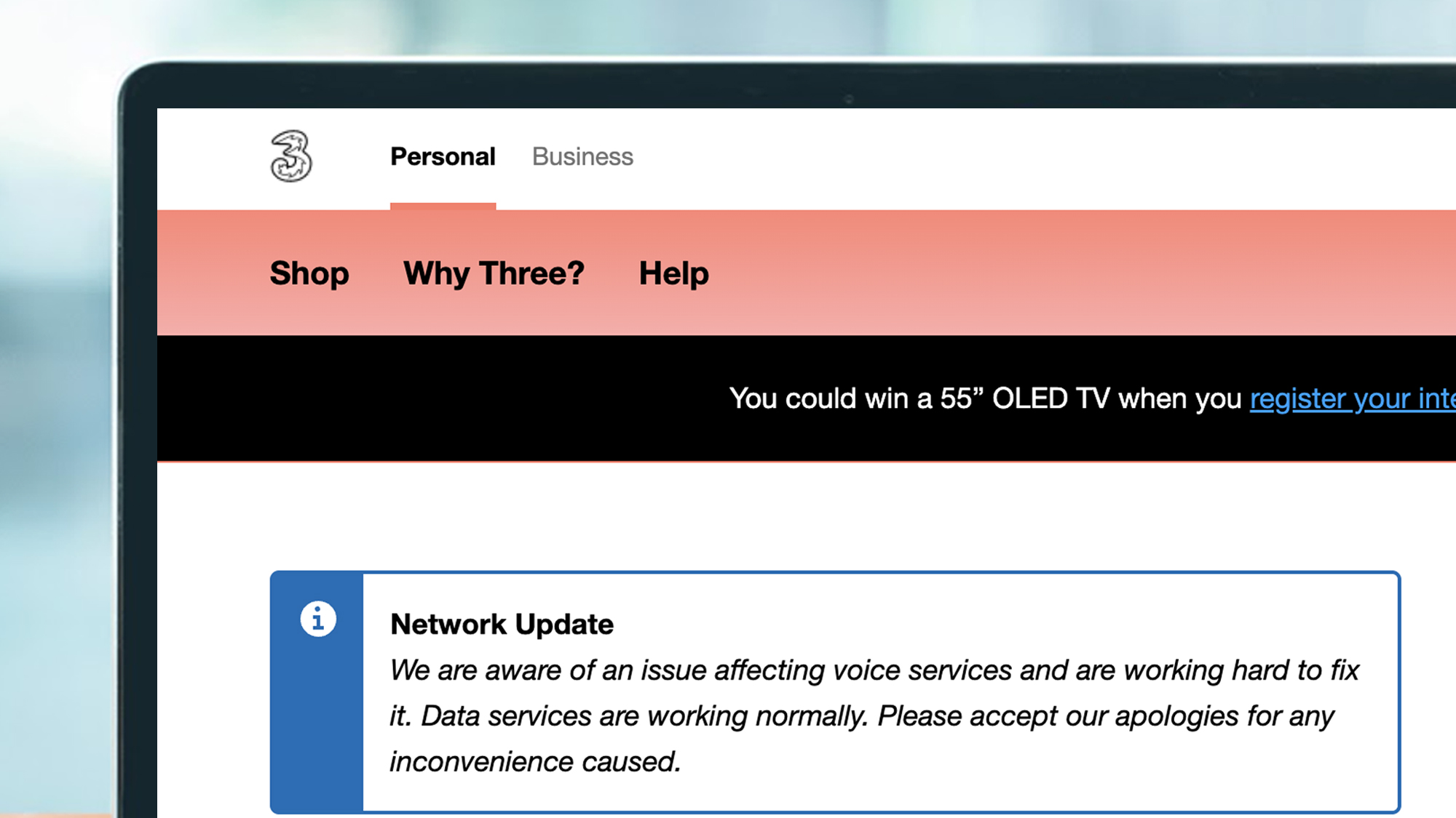 A laptop screen showing the Three UK homepage with an acknowledgement of network issues