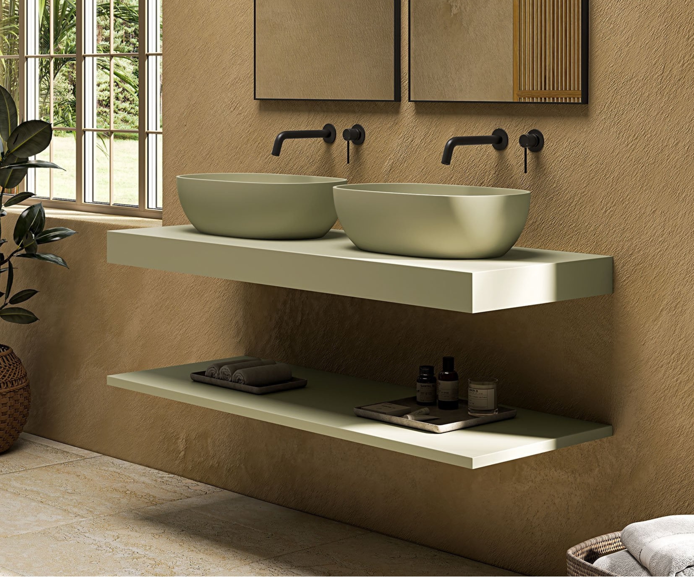 Two oval sage green vessel basins on floating shelf, black wall-mounted taps, textured earthy wall.