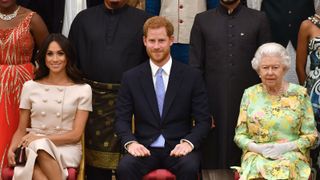 LONDON, ENGLAND - JUNE 26: Meghan, Duchess of Sussex, Prince Harry, Duke of Sussex and Queen Elizabeth II at the Queen's Young Leaders Awards Ceremony at Buckingham Palace on June 26, 2018 in London, England. The Queen's Young Leaders Programme, now in its fourth and final year, celebrates the achievements of young people from across the Commonwealth working to improve the lives of people across a diverse range of issues including supporting people living with mental health problems, access to education, promoting gender equality, food scarcity and climate change.