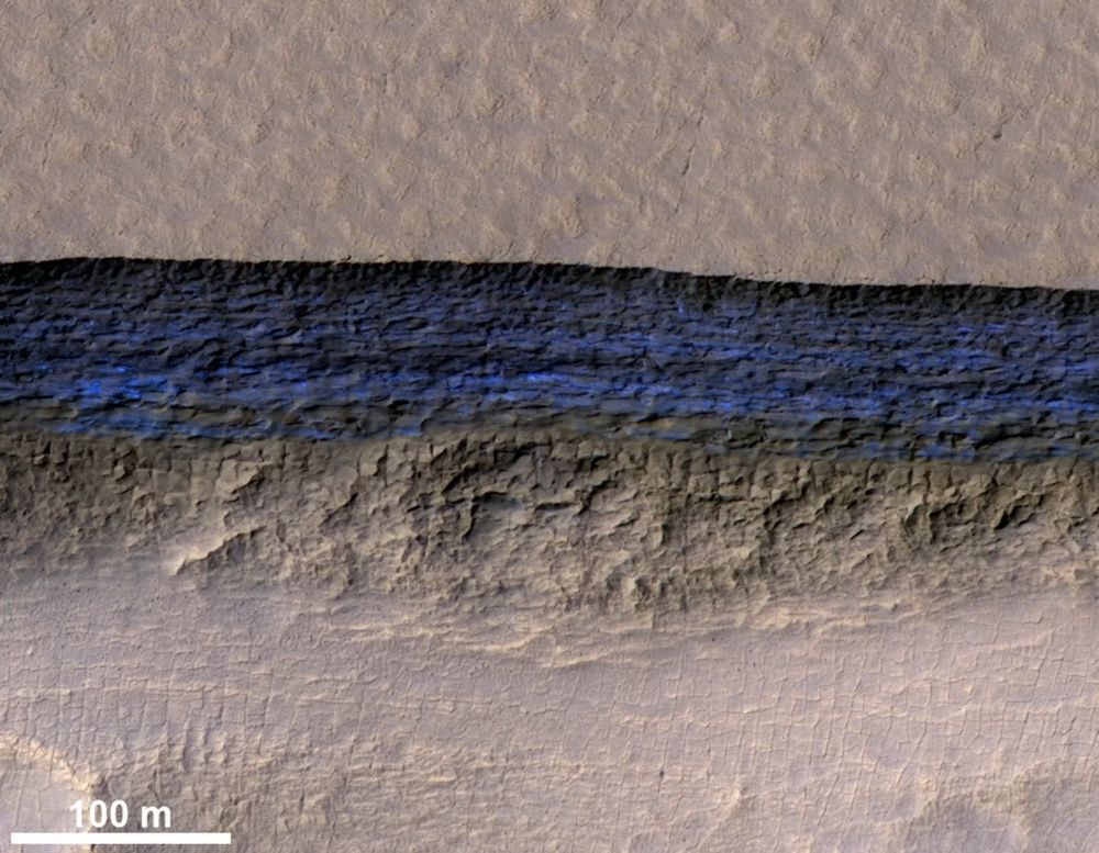 This photo by the HiRISE camera aboard NASA’s Mars Reconnaissance Orbiter shows a detailed subsection of an icy scarp on the Red Planet in enhanced color. 