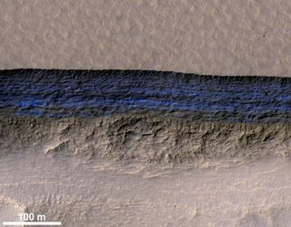 This photo by the HiRISE camera aboard NASA’s Mars Reconnaissance Orbiter shows a detailed subsection of an icy scarp on the Red Planet in enhanced color. 