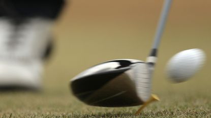  Close-up of a club hitting a ball off the tee