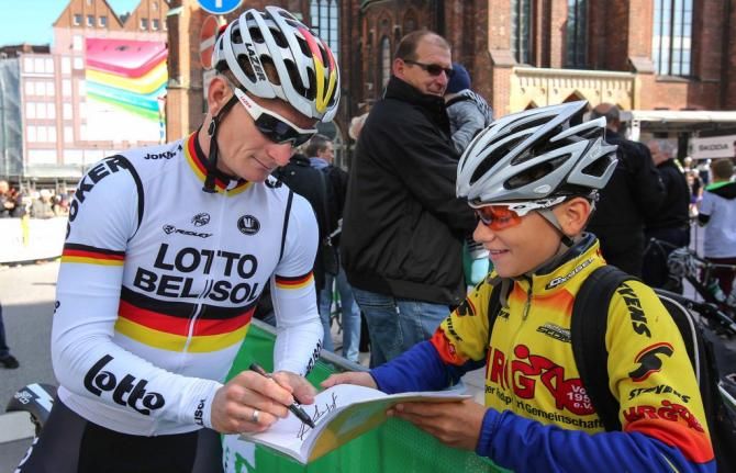 Andr&eacute; Greipel (Lotto-Belisol) signing an autograph for a young fan
