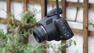 Blackmagic Pocket Cinema Camera 6K Pro hengende i stroppen sin i en hage