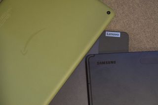 The Lenovo Tab P11 Plus, Samsung Galaxy S7 FE, and Amazon Fire HD 10 Plus in a pile